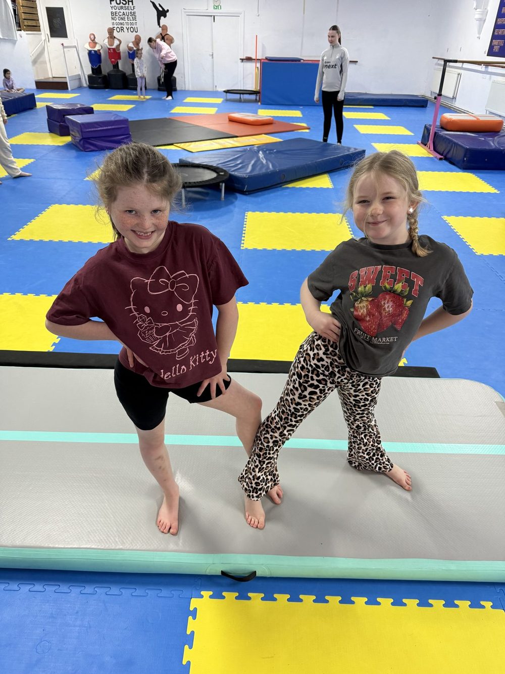 Two gymnasts on the air track