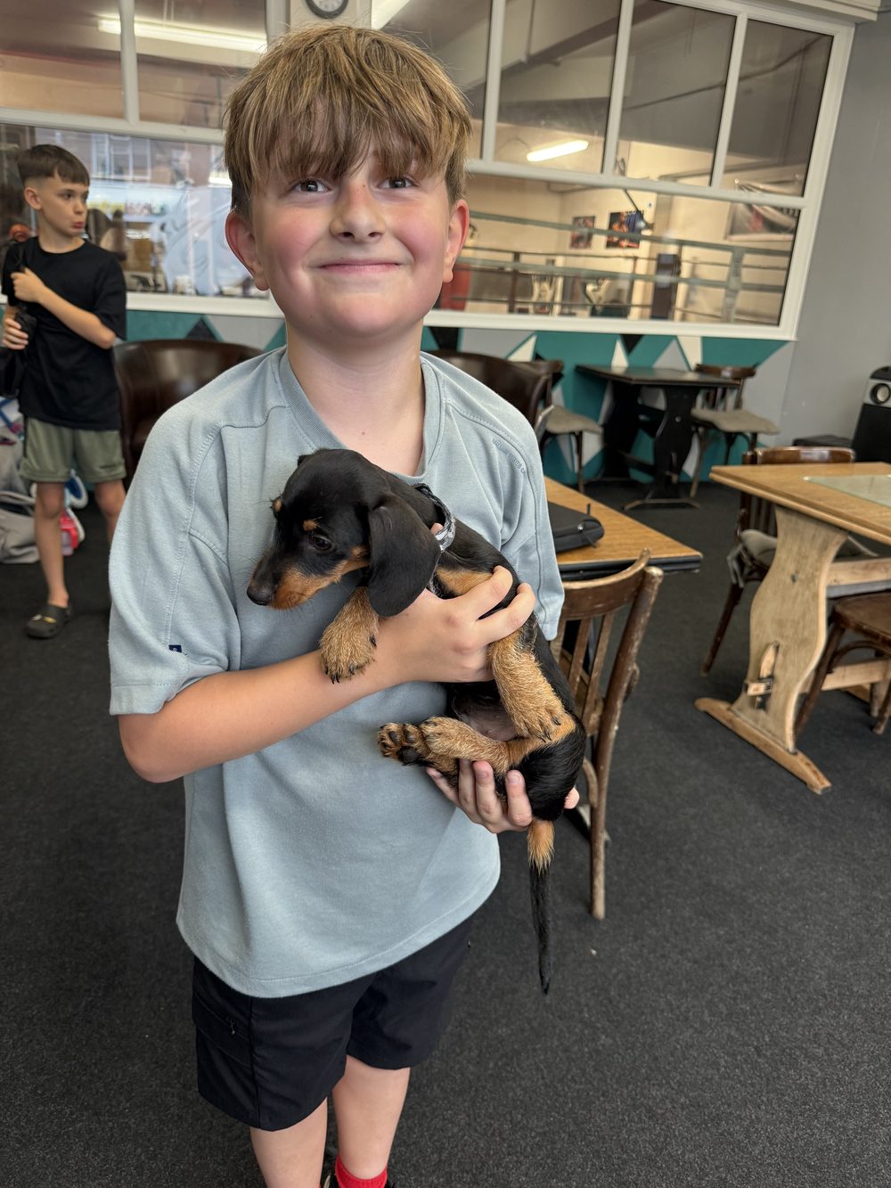 A young gymnast holding a puppy